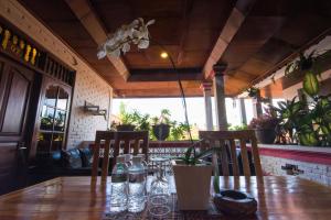 a wooden table with chairs and water bottles on it at Radha Homestay in Sanur
