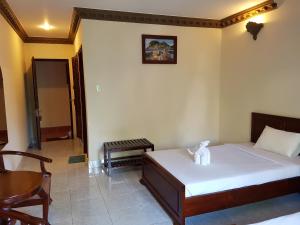 Cama o camas de una habitación en Vinh Suong Seaside Hotel and Resort