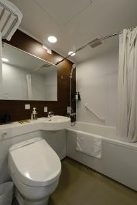 a bathroom with a toilet and a sink and a tub at Hotel Il Fiore Kasai in Tokyo +24 photos