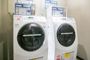 two washing machines are standing next to each other at Hotel Brighton City Osaka Kitahama in Osaka