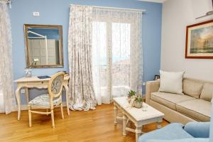 a living room with a couch and a table at PEPO'S GUESTHOUSE in Nafpaktos