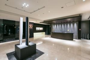 a lobby with a large room with black walls at Hotel Brighton City Osaka Kitahama in Osaka