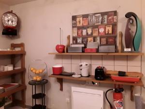 a kitchen with wooden shelves on the wall at La Grange de Marie in Nitry