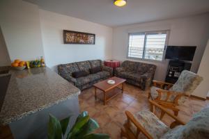 a living room with a couch and a table at Apartamento Voramar in Daimuz