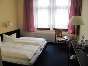 Postel nebo postele na pokoji v ubytování Hotel Wettin