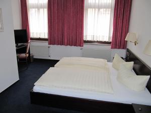 Postel nebo postele na pokoji v ubytování Hotel Wettin