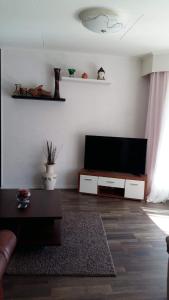 a living room with a flat screen tv on a wall at 4 Bedrooms near Center - Kranni in Pori