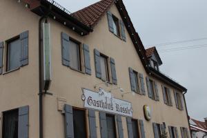 a building with a sign on the side of it at Gasthof Rössle Ochsenwang in Bissingen an der Teck