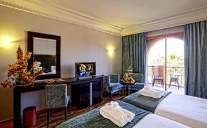 Postel nebo postele na pokoji v ubytování Palm Plaza Marrakech