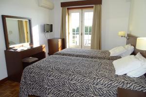 A bed or beds in a room at Hotel Mira Rio