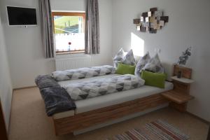 a couch with pillows on it in a living room at Unterbleiwanghof in Radstadt