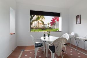 エステポナにあるApartment Muñozの窓付きの客室で、白いテーブルと椅子が備わります。