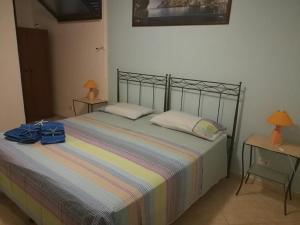 a bedroom with a bed and two tables with lamps at b&b Bellavista in Castro di Lecce