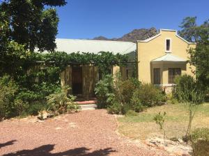 an old house with a garden in front of it at Amakhala in Montagu