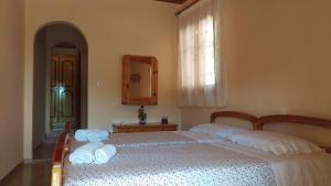 a bedroom with a large bed with towels on it at Paradise Studios in Paleokastritsa