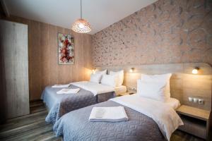 Кровать или кровати в номере Milano Palace Borjomi