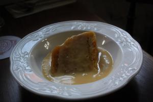 a piece of cake on a plate on a table at The Three Horseshoes in Warham