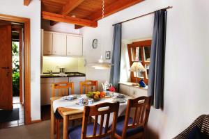 a kitchen and dining room with a table and chairs at BioDohrn in Bad Zwischenahn