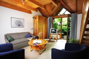 a living room with a couch and a table at BioDohrn in Bad Zwischenahn