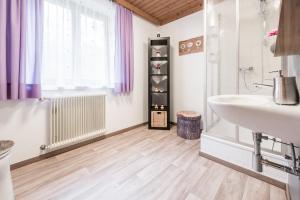a bathroom with a sink and a tub and a sink at Apartment Haus Gold in Fusch an der Glocknerstraße +51 photos