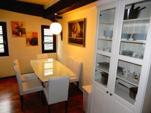 a dining room with a table and white chairs at Gasthaus Burgkeller in Limburg an der Lahn