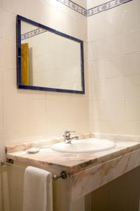 a bathroom with a sink and a mirror at Vinha da Quinta in Sintra