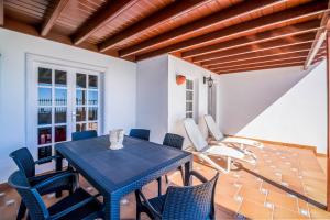 a dining room with a blue table and chairs at Villa Tías in Tías