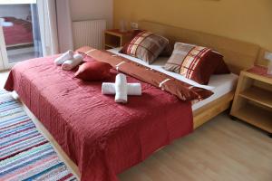 a bedroom with a bed with two stuffed animals on it at Ferienwohnungen Maurer in Umhausen