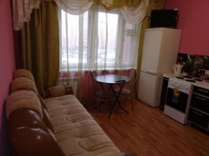 イヴァノヴォにあるApartments on Moskovskiy 12のリビングルーム(ソファ、テーブル付)、キッチンが備わります。