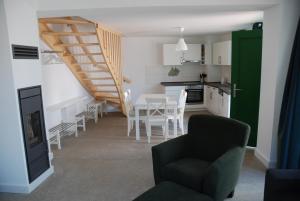 a kitchen and dining room with a table and chairs at Remise am Schlosspark in Schwielowsee