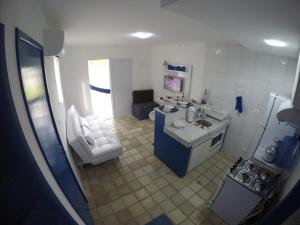 a small kitchen with a sink and a stove at Village Galés Maragogi - Chalé 03 in Maragogi
