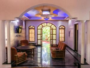 a living room with an archway and a table and chairs at Palolem Apartments in Palolem