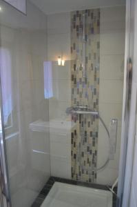 a bathroom with a shower with a glass door at Coeur d'Alsace 3 in Kaysersberg +16 photos