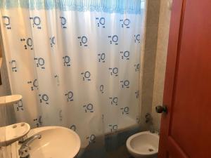 a bathroom with a shower curtain with numbers on it at Departamentos Belgrano in Salta +68 photos