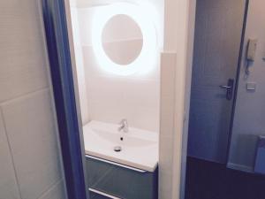 a bathroom with a sink and a mirror at les pieds dans l'eau in Wimereux +9 photos