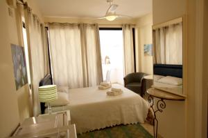 a hotel room with a bed and a window at Pissouri Village Studios in Pissouri