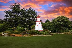 a red and white lighthouse sitting in a field at Beachwood Condos & Resort in Copalis Beach