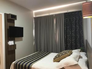Postel nebo postele na pokoji v ubytování Hotel Requinte