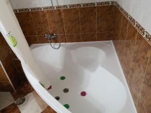 a white bath tub with colorful decorations on the floor at Piso Vacacional Isla Cristina in Isla Cristina +57 photos