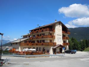 a large building with balconies on the side of it at Hotel Seggiovia in Folgaria