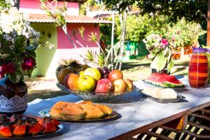 a table with two bowls of fruit on it at Pousada Mar de Estrelas in São Miguel do Gostoso