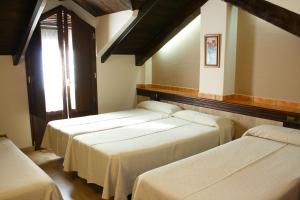 Posteľ alebo postele v izbe v ubytovaní Hotel Rural Huerta del Laurel