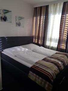 a bed sitting in a bedroom with a window at Hotel Wandsbek Hamburg in Hamburg