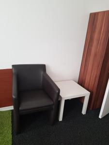 a black chair and a white table in a room at Hotel Wandsbek Hamburg in Hamburg