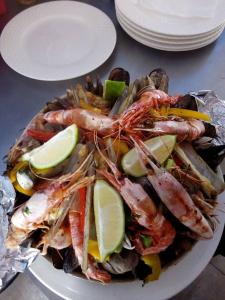 a plate of food with shrimp and vegetables on a table at Le temps perdu in Oualidia