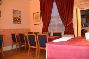 a dining room with a table and chairs and a window at Bow Guest House in Reading