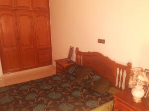 ein Schlafzimmer mit einem Bett, einer Kommode und einer Tür in der Unterkunft joli appartement 4 chambres in Oujda