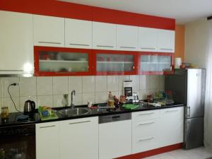 a kitchen with white cabinets and a stainless steel refrigerator at Guest house Sistem in Brčko