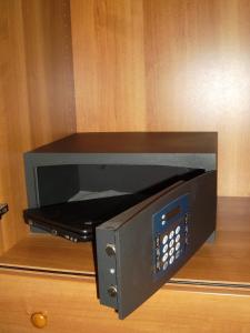 a microwave oven sitting on top of a wooden wall at Hotel Alla Dolina in Sistiana