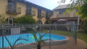 a swimming pool in front of a building at 299 On Devon West in New Plymouth